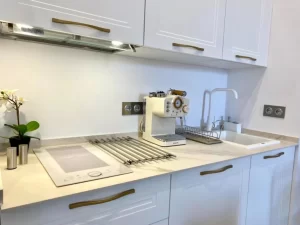 Cocina totalmente equipada de Casa Señorial Rivadavia con cafetera, placa de inducción y fregadero en el centro histórico de Cádiz