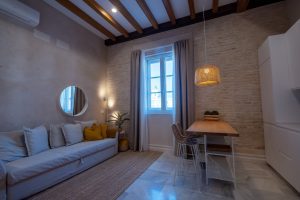 Vista amplia del apartamento con salón, comedor y cocina abierta de diseño contemporáneo.